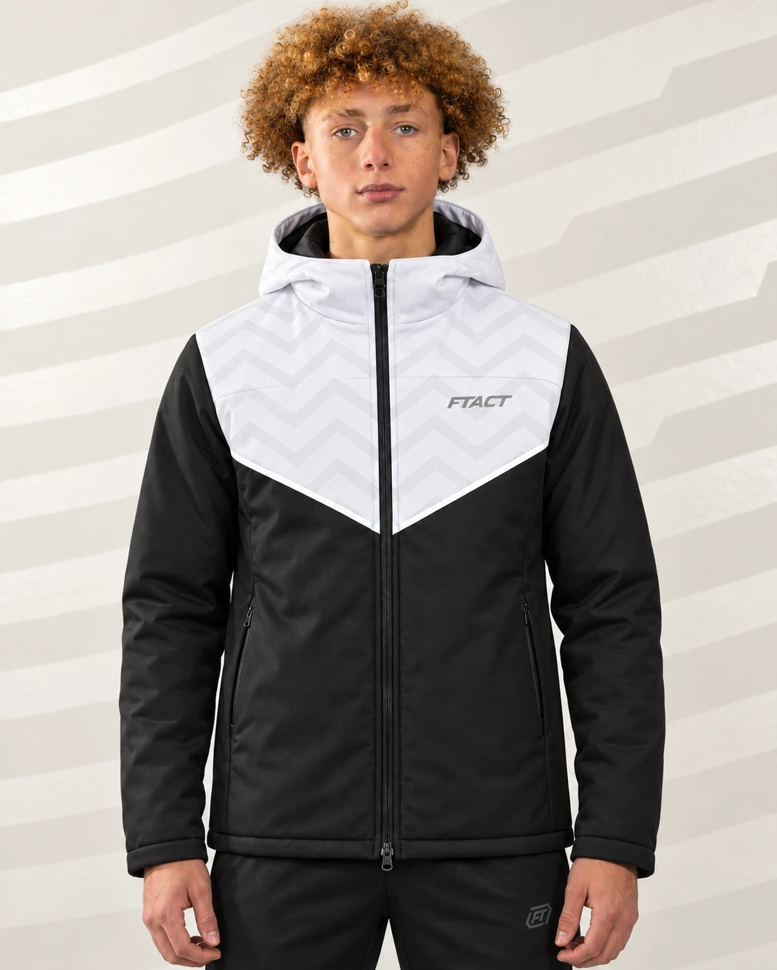 Model wearing the black and white FTACT hybrid coat in a light studio