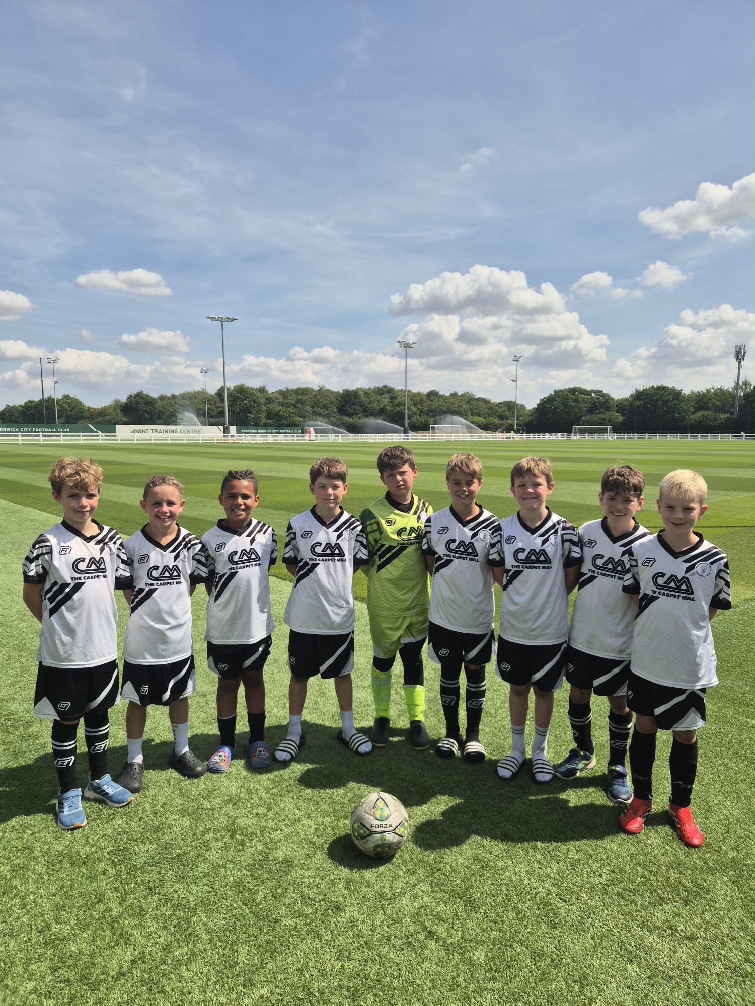 Grassroots players together on the pitch in their FTACT kits