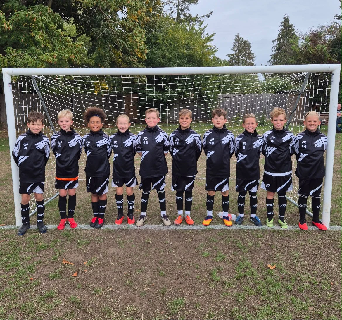A grassroots squad together in matching black and white FTACT training wear
